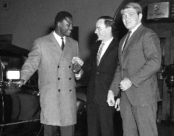 Joe Frazier, an unidentified man, and Tom McNeeley get into their limo